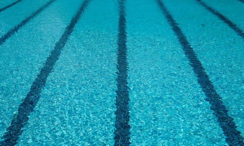 picture of a swimming pool, filled with water.  The lanes are visible